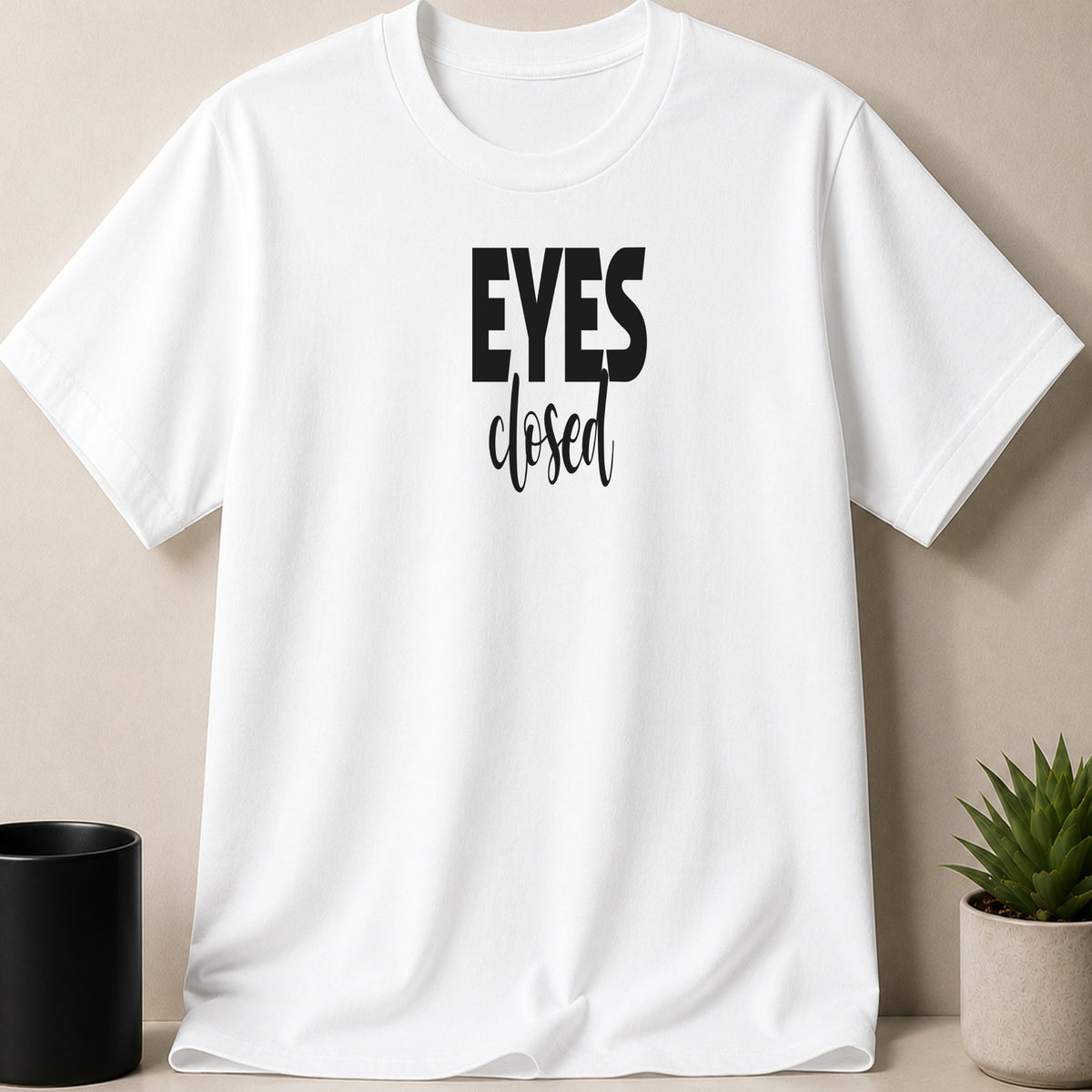 White t-shirt with black text "EYES closed" on the front.