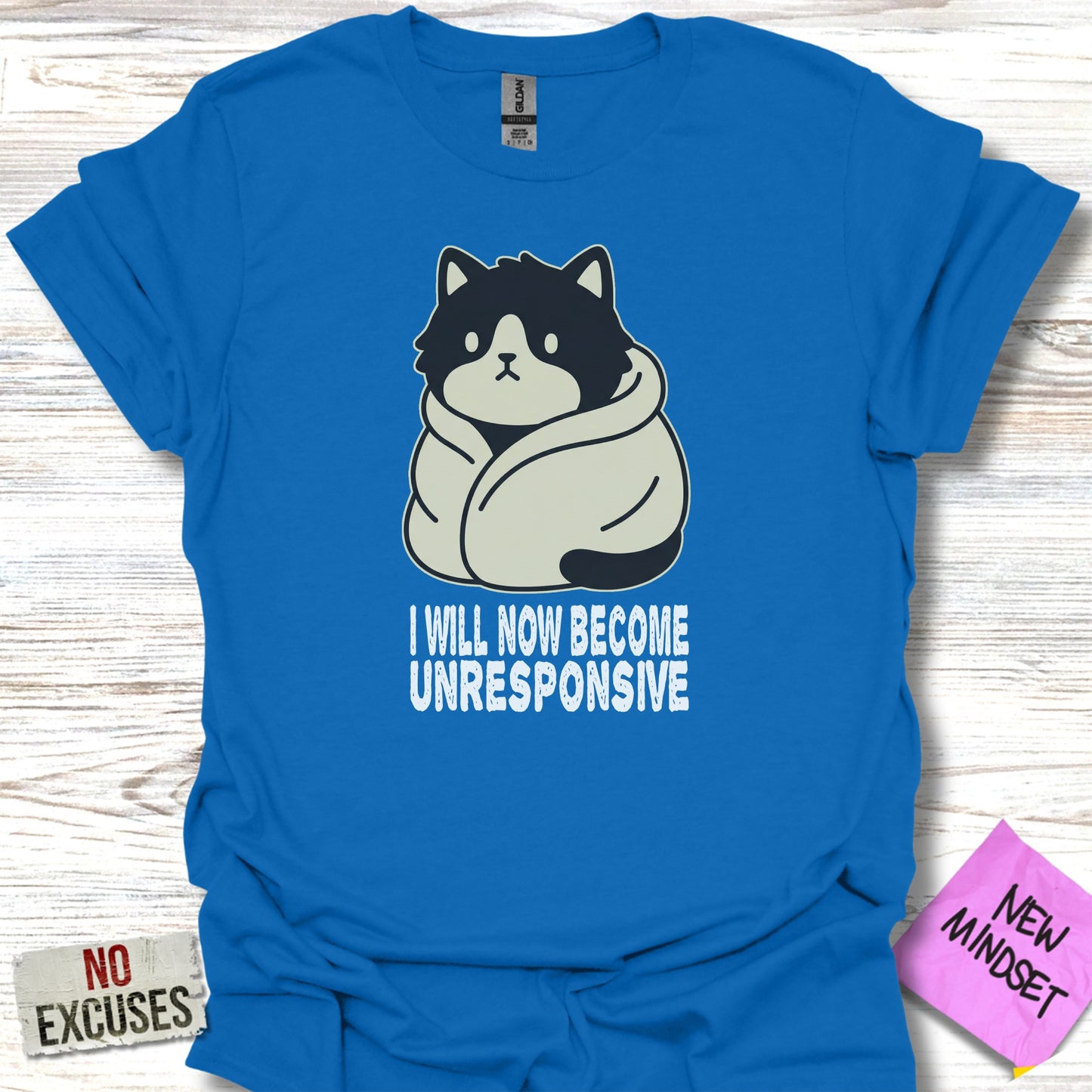 Blue t-shirt with a cartoon cat wrapped in a blanket, text "I WILL NOW BECOME UNRESPONSIVE".