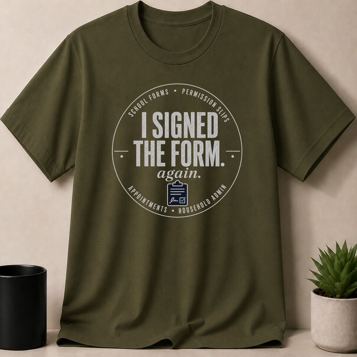 Olive green t-shirt with "I SIGNED THE FORM. again." text and icons.