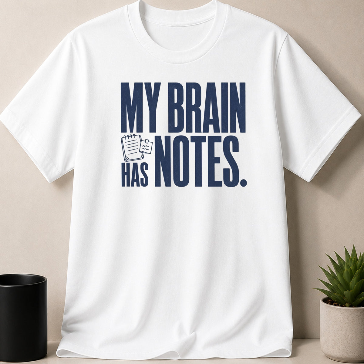White t-shirt with navy text "MY BRAIN HAS NOTES."