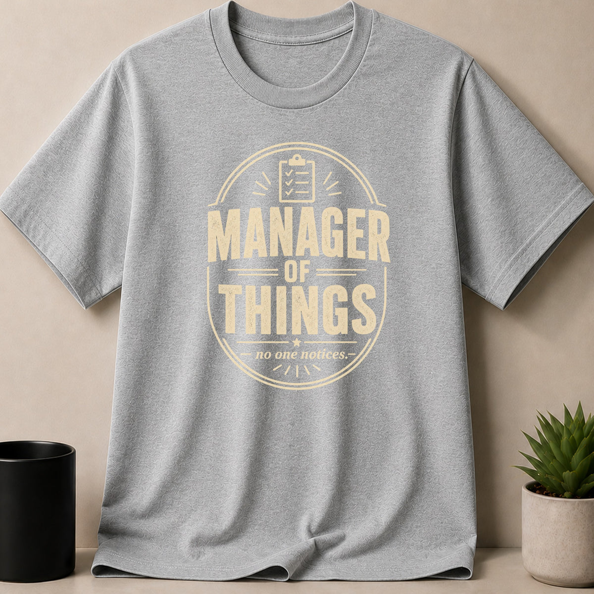 Grey t-shirt with cream graphic text "Manager of Things".
