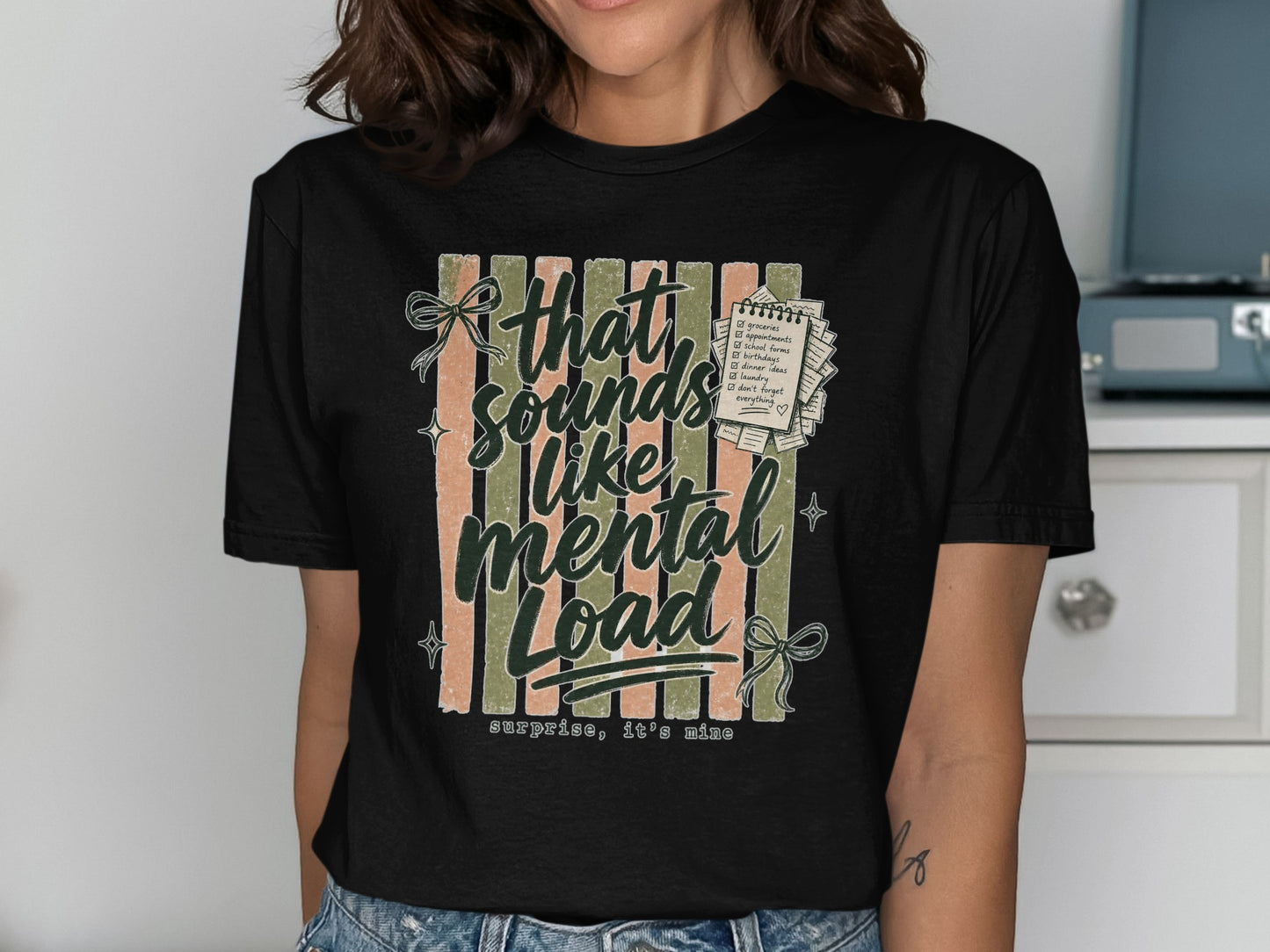 Black t-shirt with "that sounds like mental load, surprise, it's mine" and a checklist.