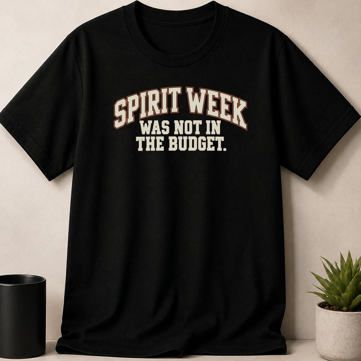 A black t-shirt printed with the text SPIRIT WEEK WAS NOT IN THE BUDGET.
