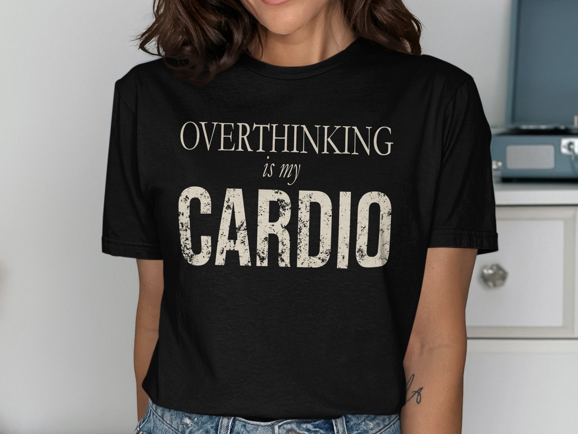 Black t-shirt with "OVERTHINKING is my CARDIO" text in cream.