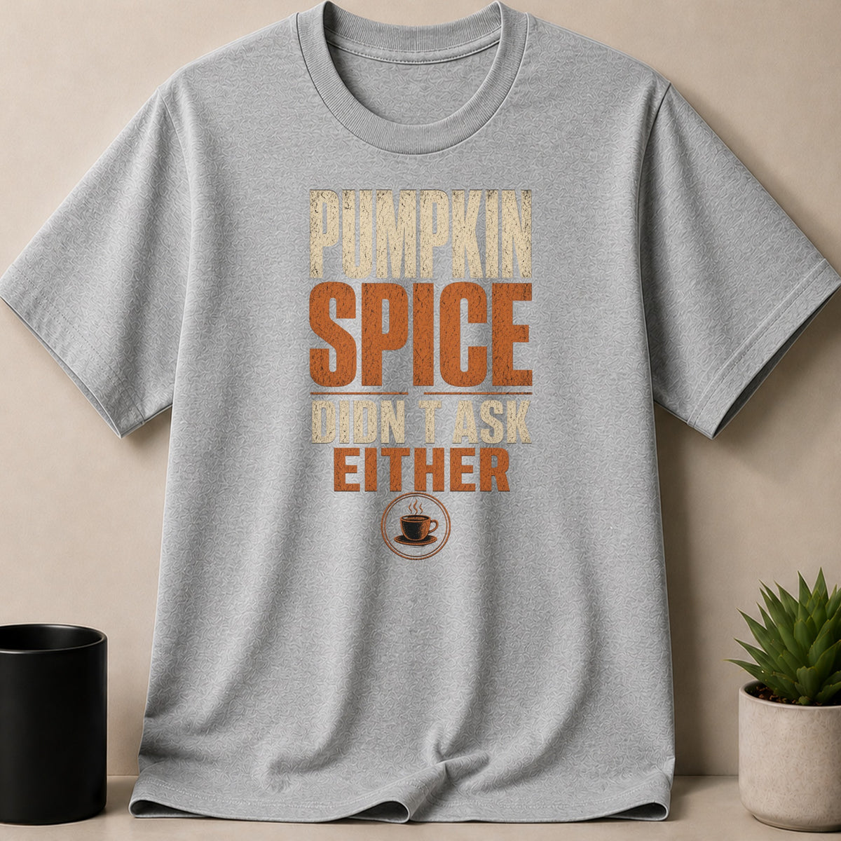 Grey t-shirt with "Pumpkin Spice Didn't Ask Either" text and coffee cup graphic.
