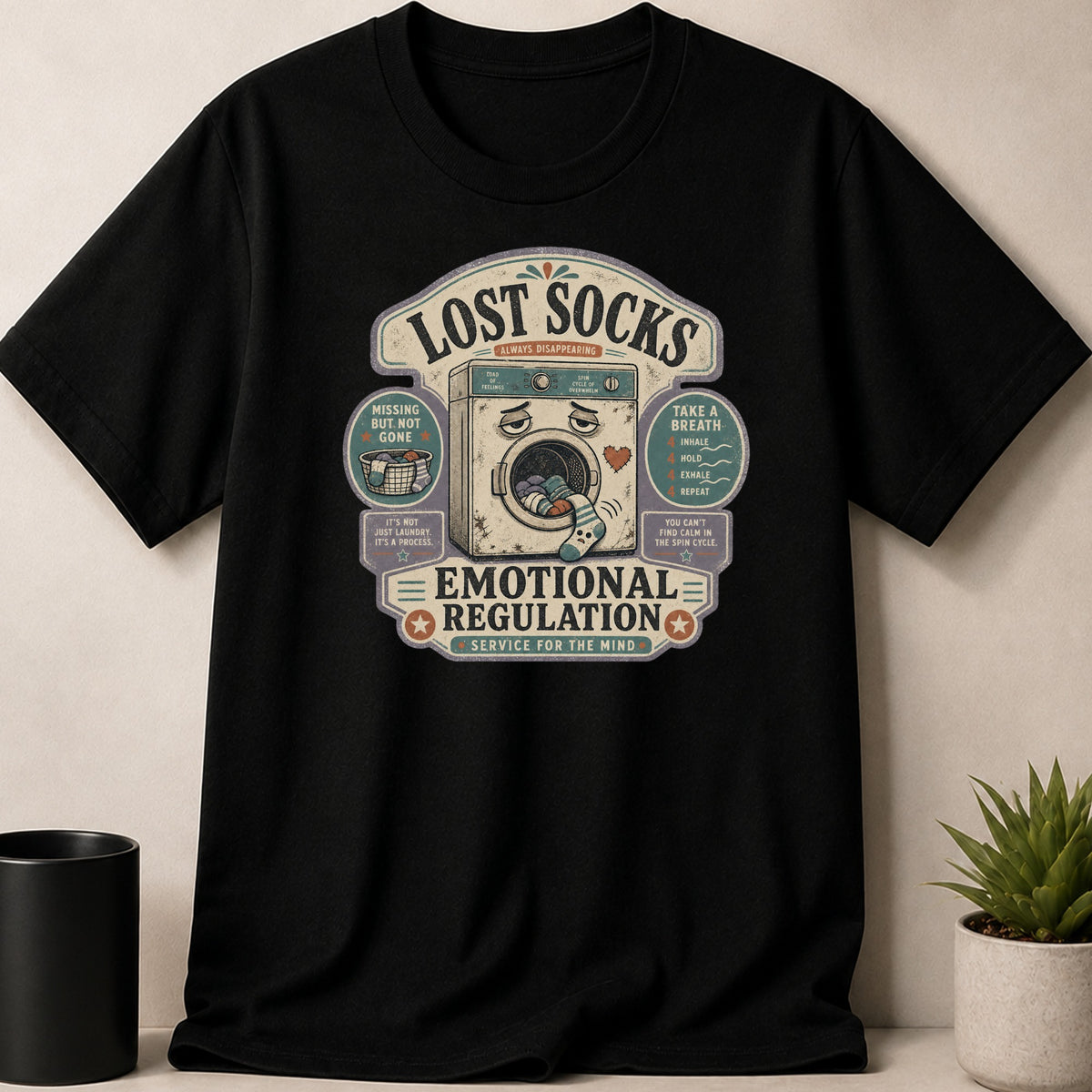 Black t-shirt with "Lost Socks, Emotional Regulation" graphic.