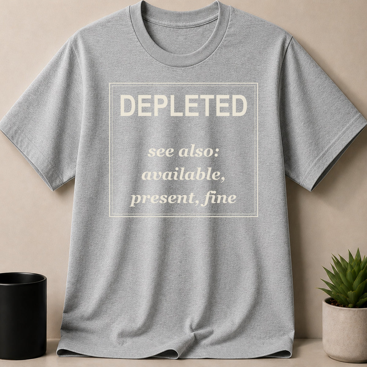 Grey t-shirt with text "DEPLETED see also: available, present, fine" inside a box.