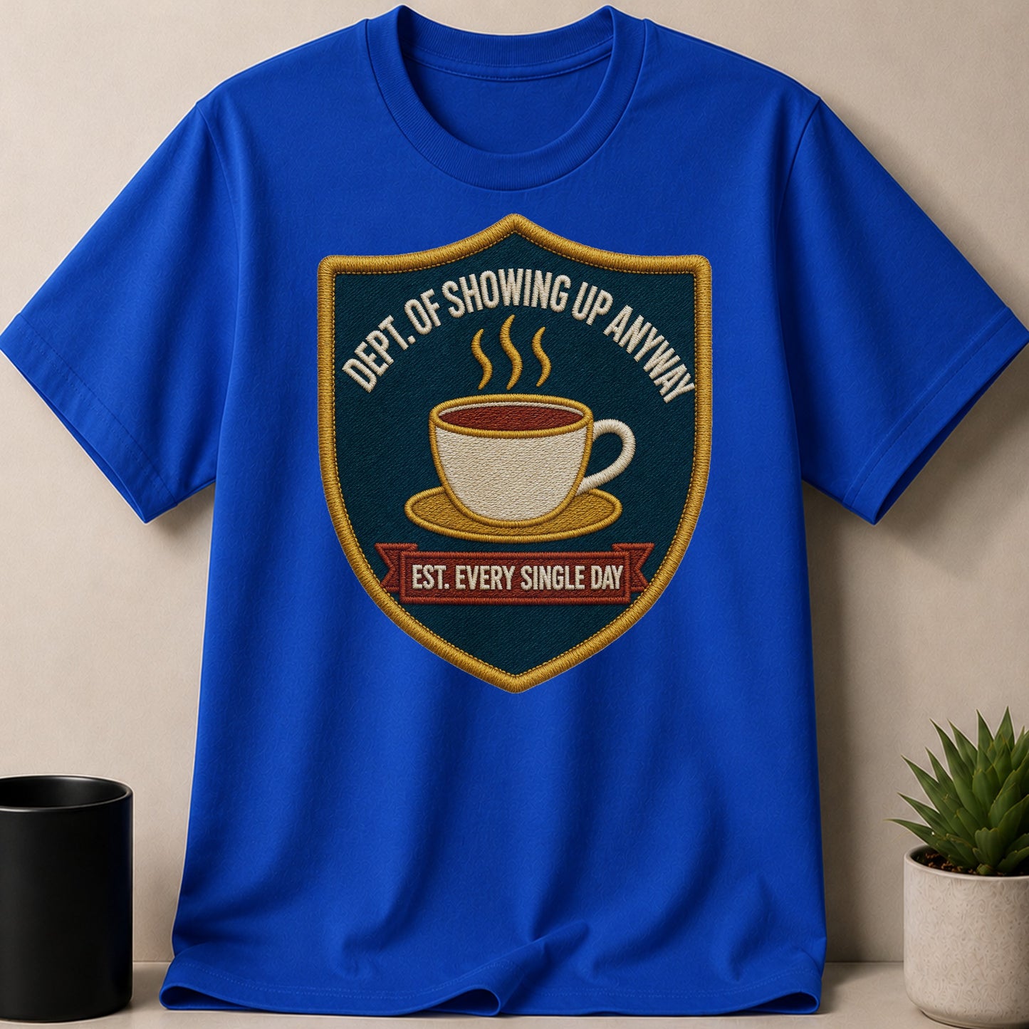 Royal blue t-shirt featuring a shield patch with a coffee cup and text.