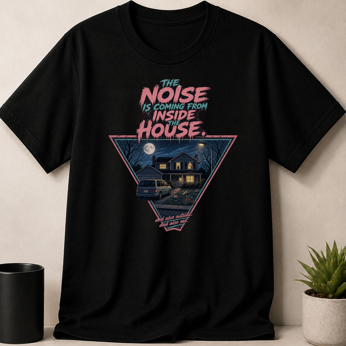 Black t-shirt with "The Noise Is Coming From Inside The House" text and a scene.