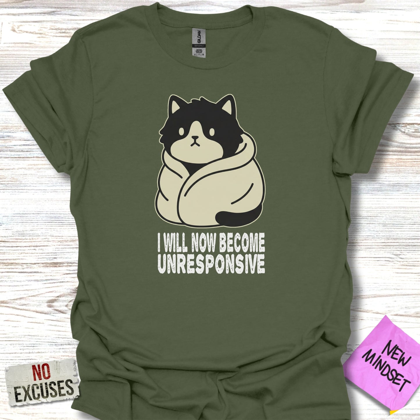 Green t-shirt with a drawing of a grumpy cat wrapped in a blanket and text that says "I will now become unresponsive."