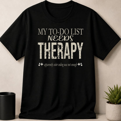Black t-shirt with "MY TO-DO LIST NEEDS THERAPY" text and decorative elements.