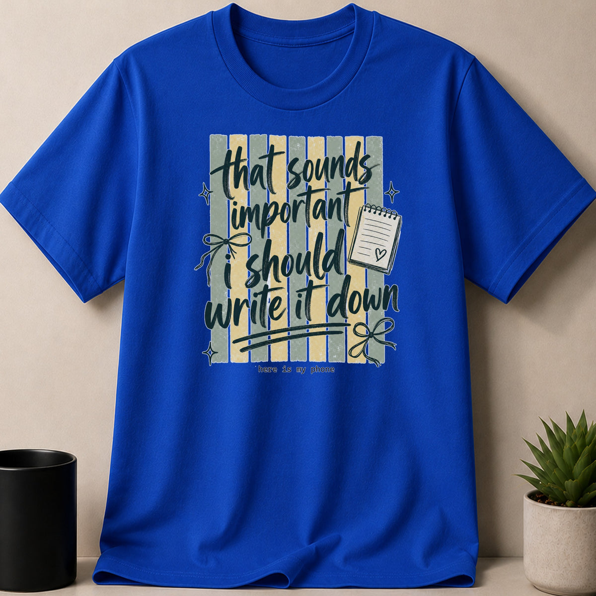 Blue t-shirt with text: "that sounds important i should write it down"