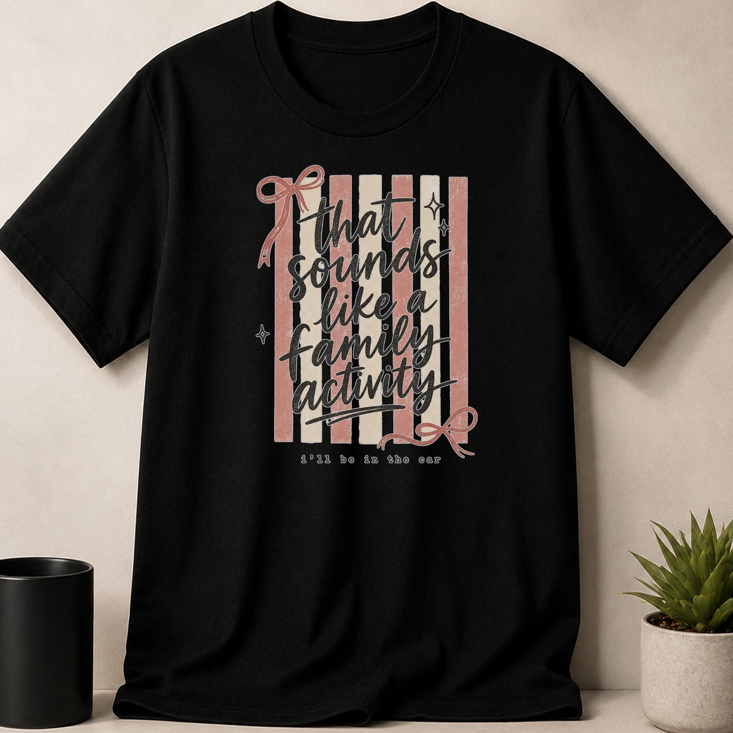 Black t-shirt with text "that sounds like a family activity i'll be in the car".