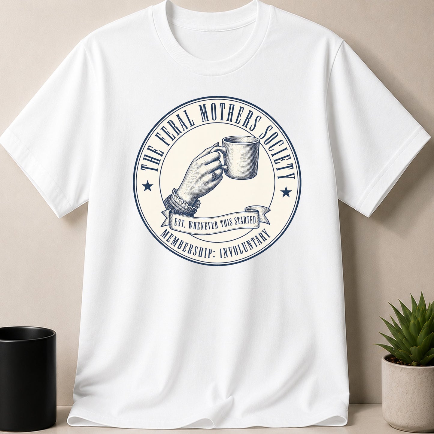 White t-shirt with circular graphic: "The Feral Mothers Society" and "Membership: Involuntary."