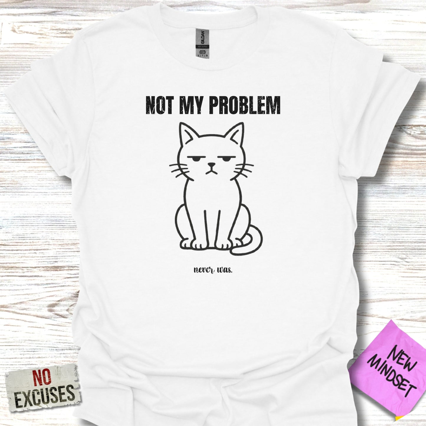 White t-shirt with black graphic of a grumpy cat and text "NOT MY PROBLEM" and "never, was."