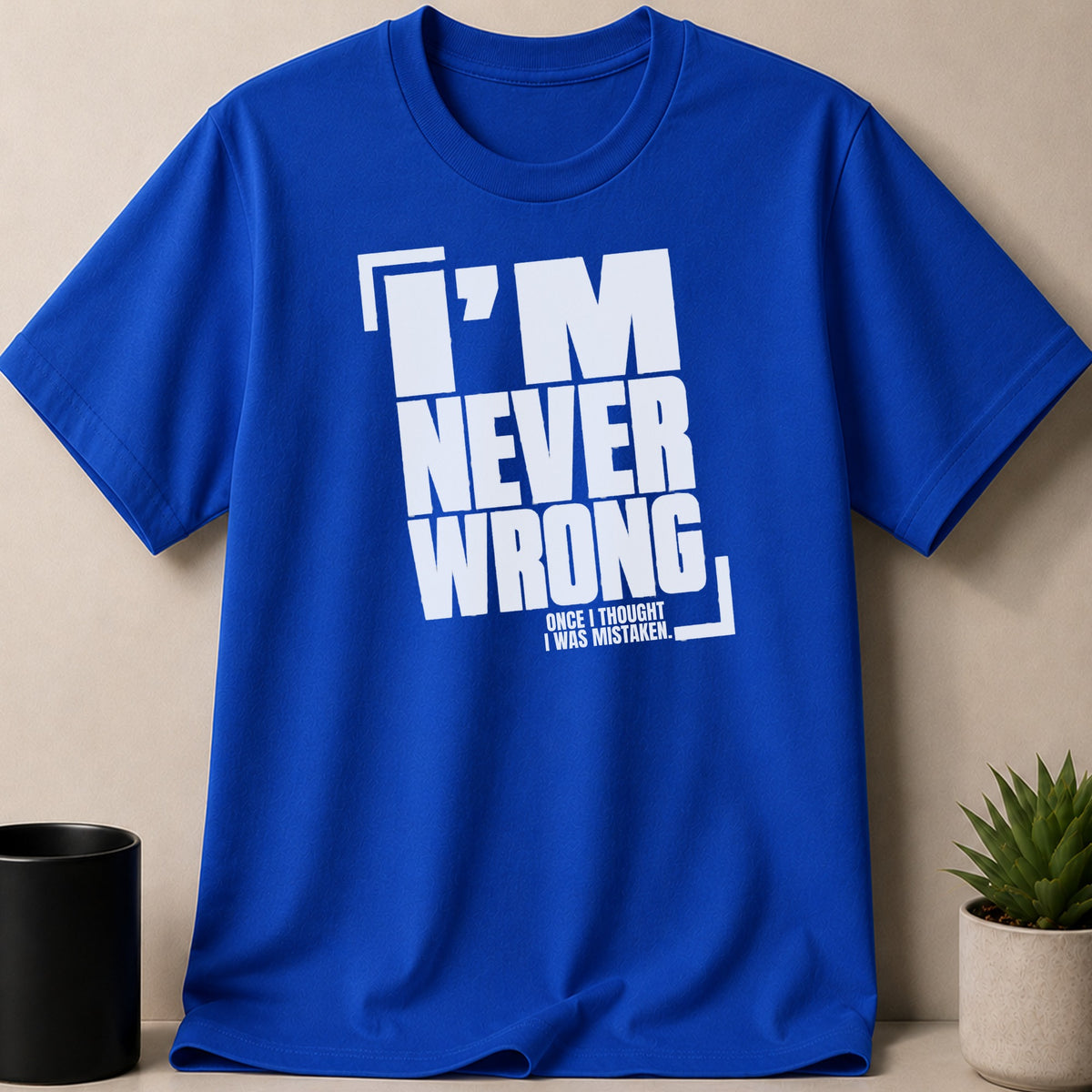 Royal blue t-shirt with "I'M NEVER WRONG" text and a smaller quote.
