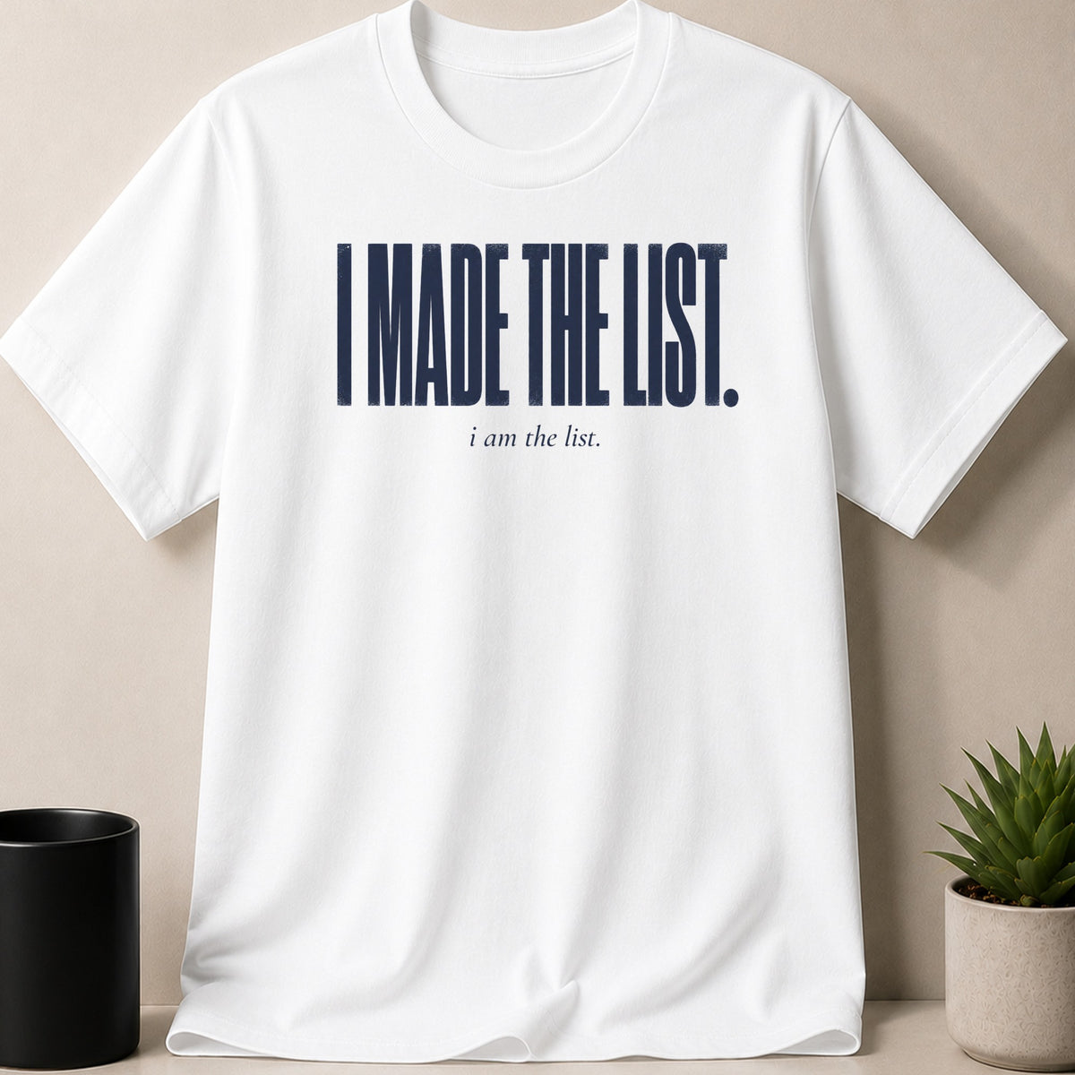 White t-shirt with navy text reading "I MADE THE LIST. i am the list."
