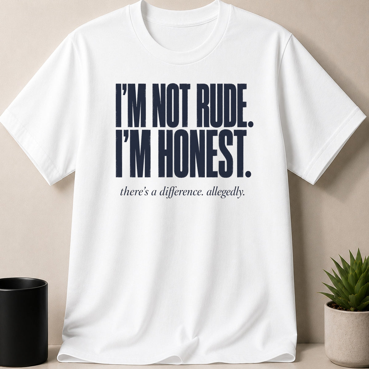 White t-shirt with navy text "I'M NOT RUDE. I'M HONEST. there's a difference. allegedly."