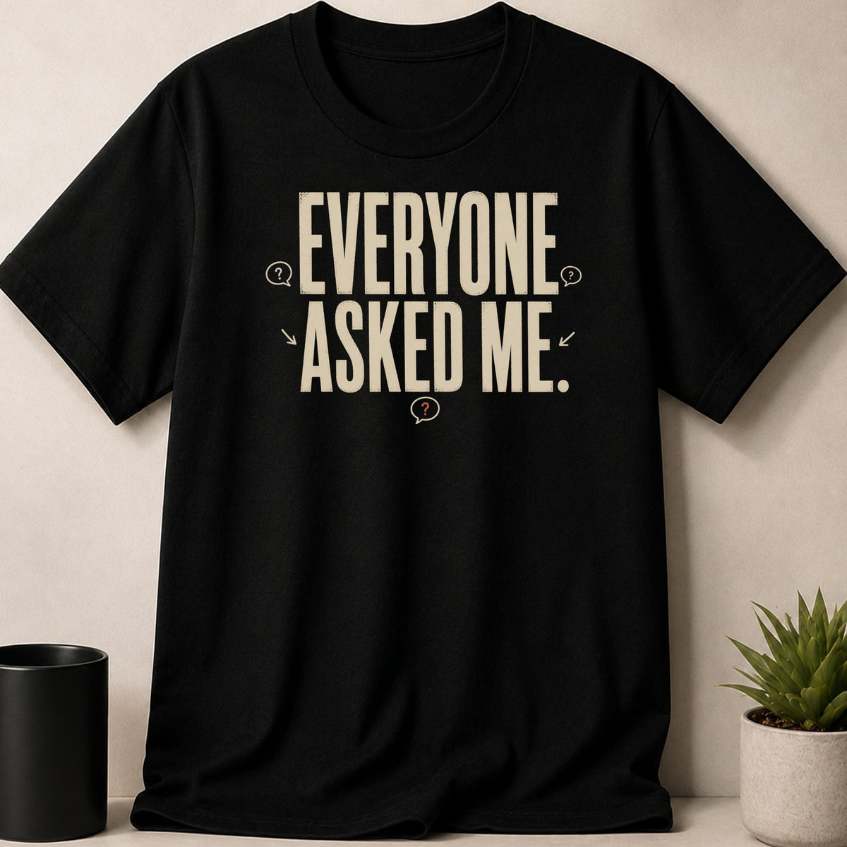 Black t-shirt with 'EVERYONE ASKED ME.' text and question marks.