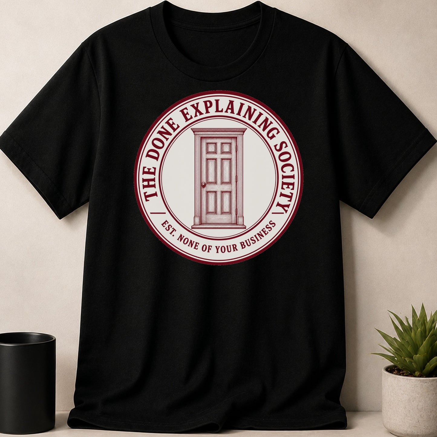 Black t-shirt with "The Done Explaining Society" and a door logo.