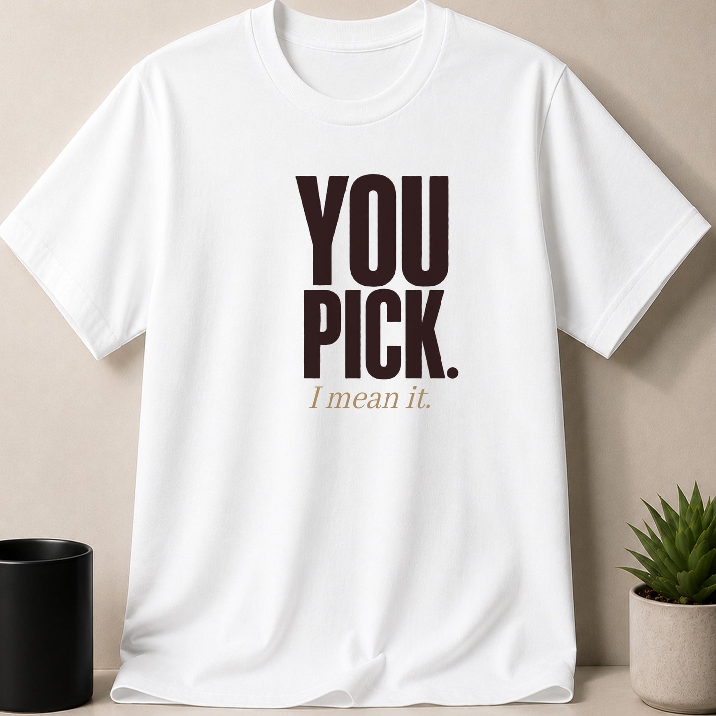 White t-shirt with dark brown text reading "YOU PICK. I mean it."