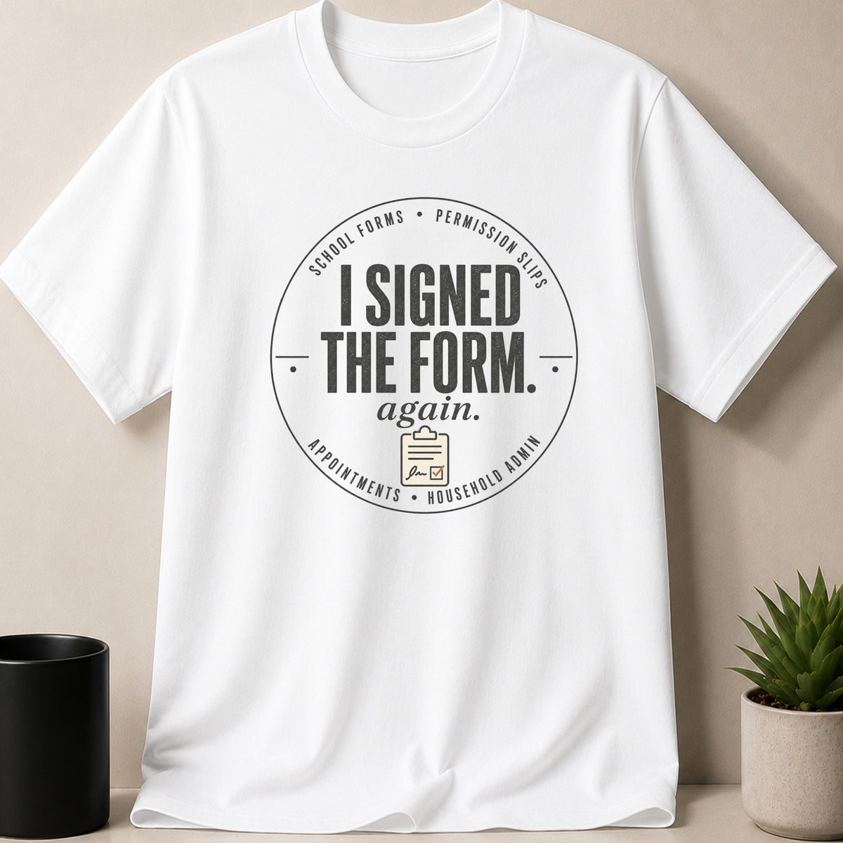 White t-shirt with text "I SIGNED THE FORM. again." and a clipboard icon.