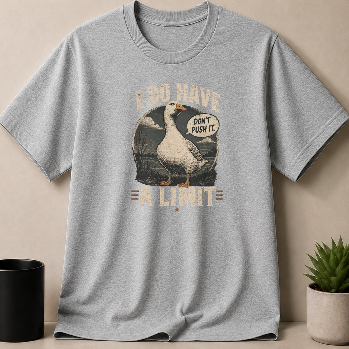 Grey t-shirt with a goose graphic that says "I DO HAVE A LIMIT. DON'T PUSH IT."