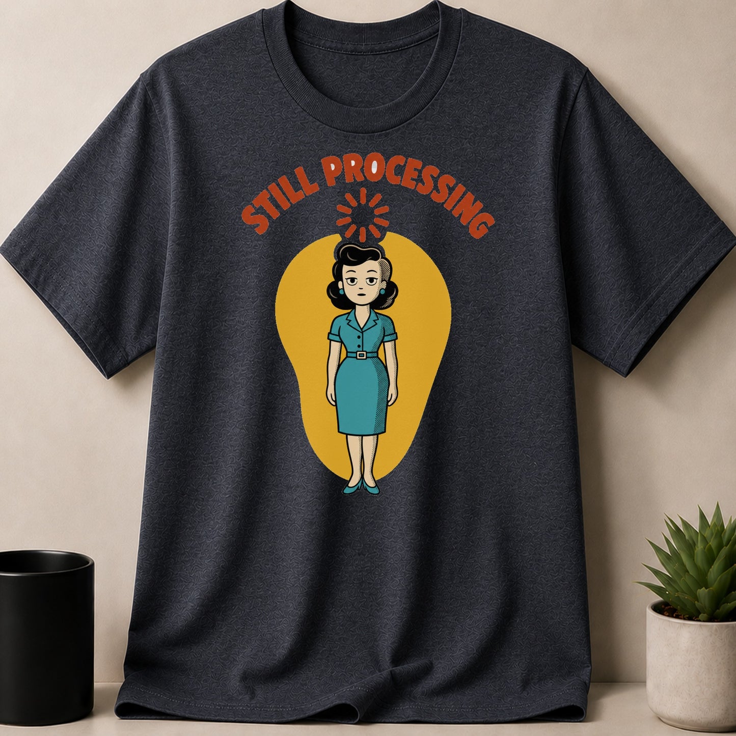Dark t-shirt with graphic of woman and text "STILL PROCESSING"