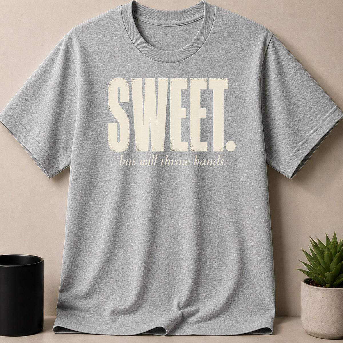 Grey t-shirt with "SWEET. but will throw hands." graphic.