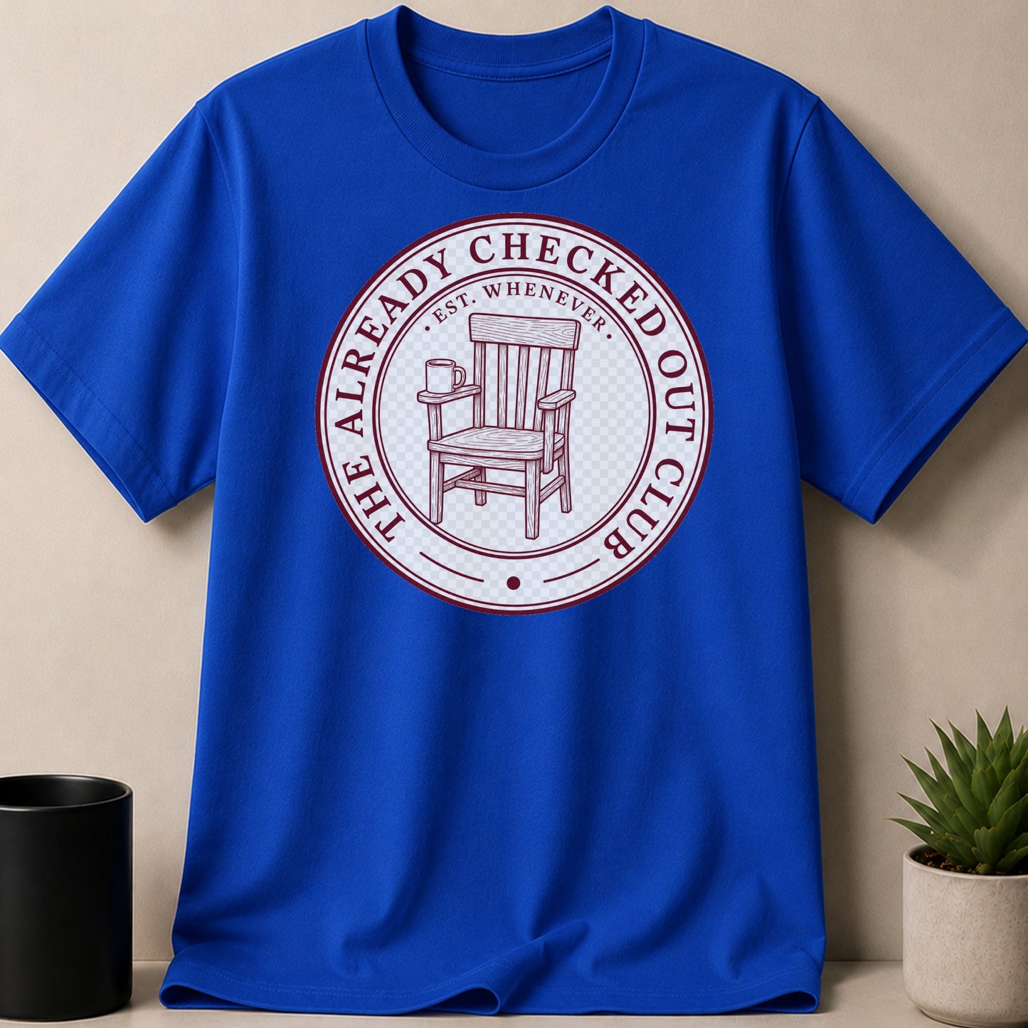 Blue t-shirt with "The Already Checked Out Club" text and a chair graphic.