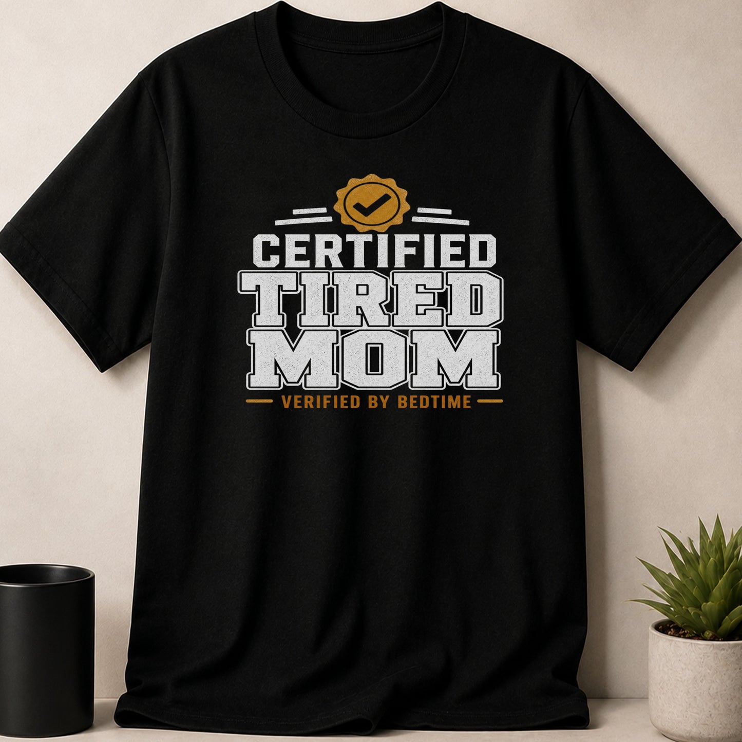 Black t-shirt with "Certified Tired Mom" text verified by bedtime.