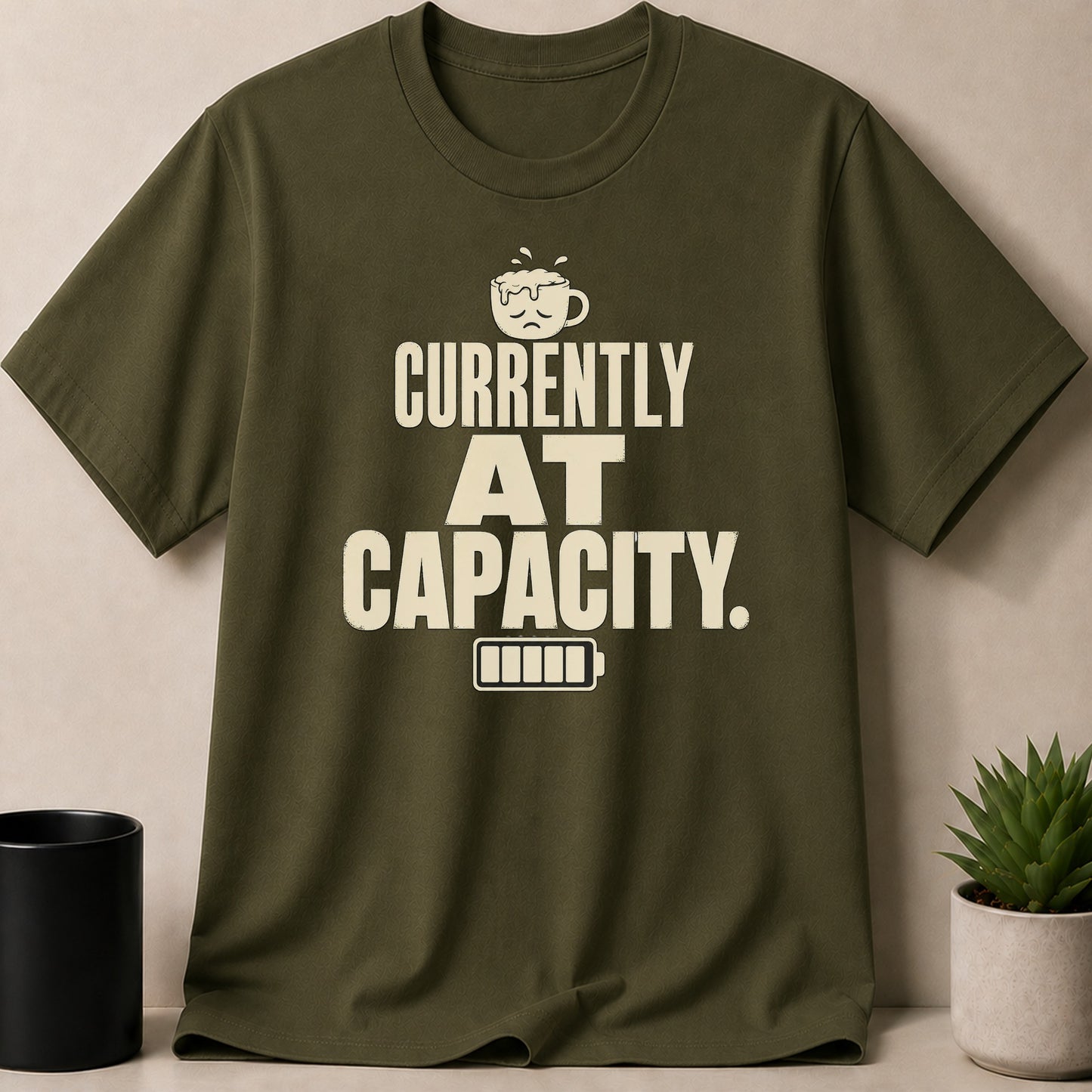 Olive green t-shirt with black text and sad coffee cup graphic.