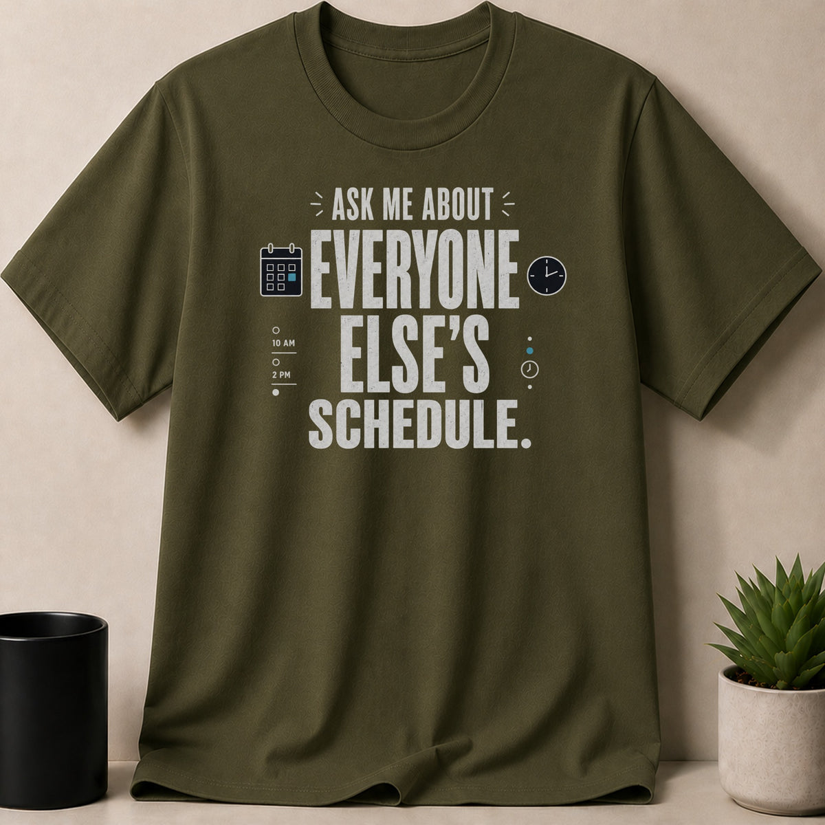 Olive t-shirt with white text "ASK ME ABOUT EVERYONE ELSE'S SCHEDULE."