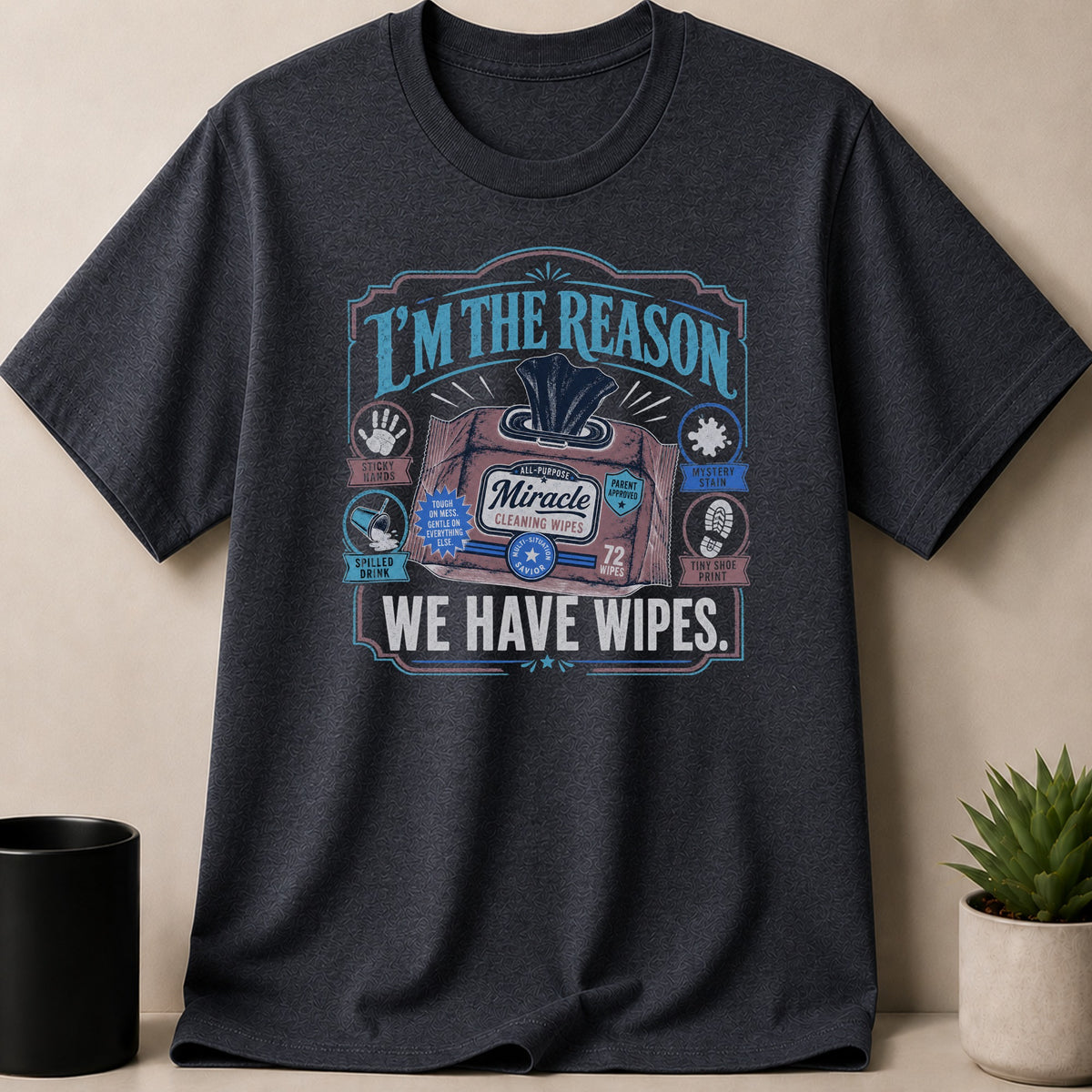 Dark t-shirt with graphic "I'M THE REASON WE HAVE WIPES." and a wipe pack.