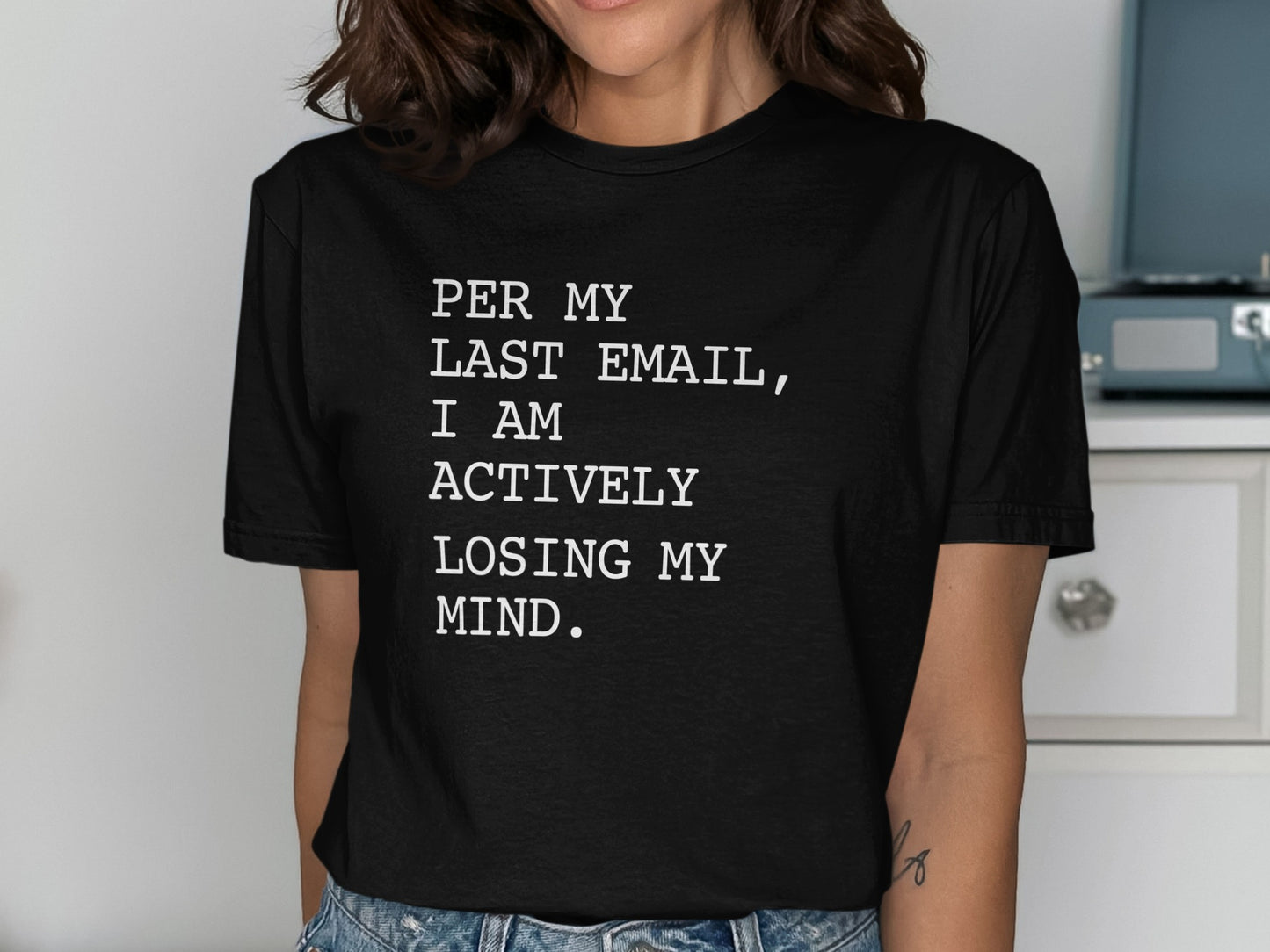 Black t-shirt with white text: "PER MY LAST EMAIL, I AM ACTIVELY LOSING MY MIND."