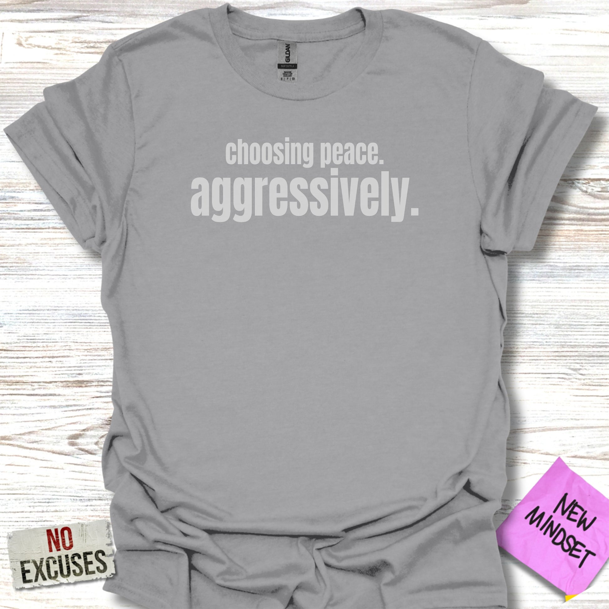 Gray t-shirt with "choosing peace. aggressively." printed in white text.
