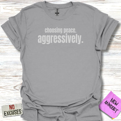 Gray t-shirt with "choosing peace. aggressively." printed in white text.