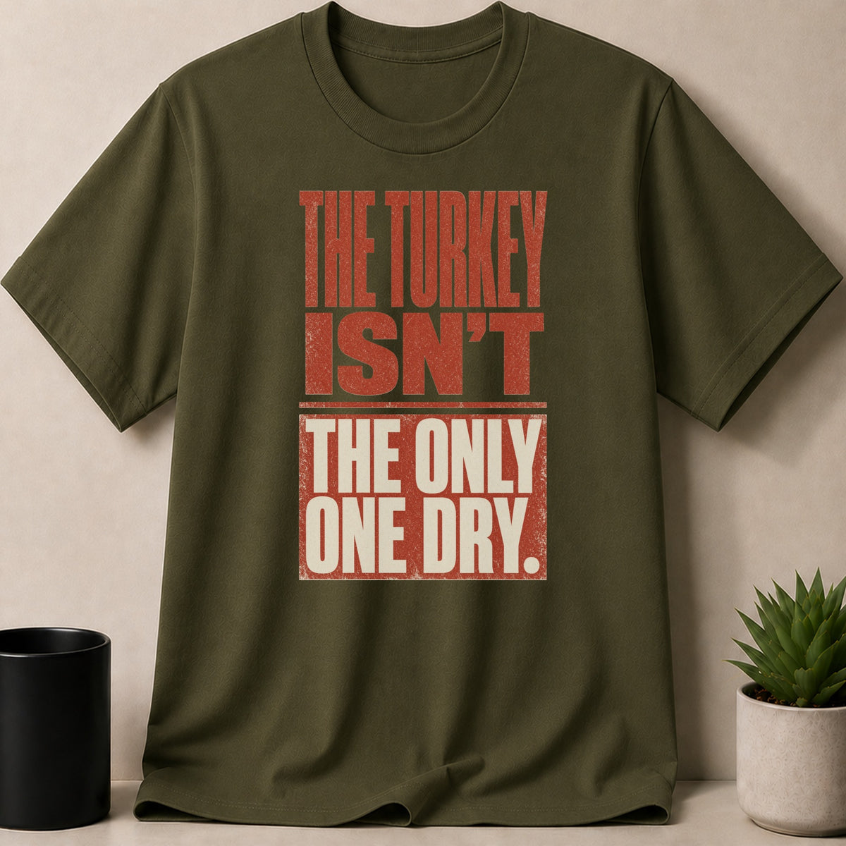 Olive green t-shirt with distressed text "THE TURKEY ISN'T THE ONLY ONE DRY."