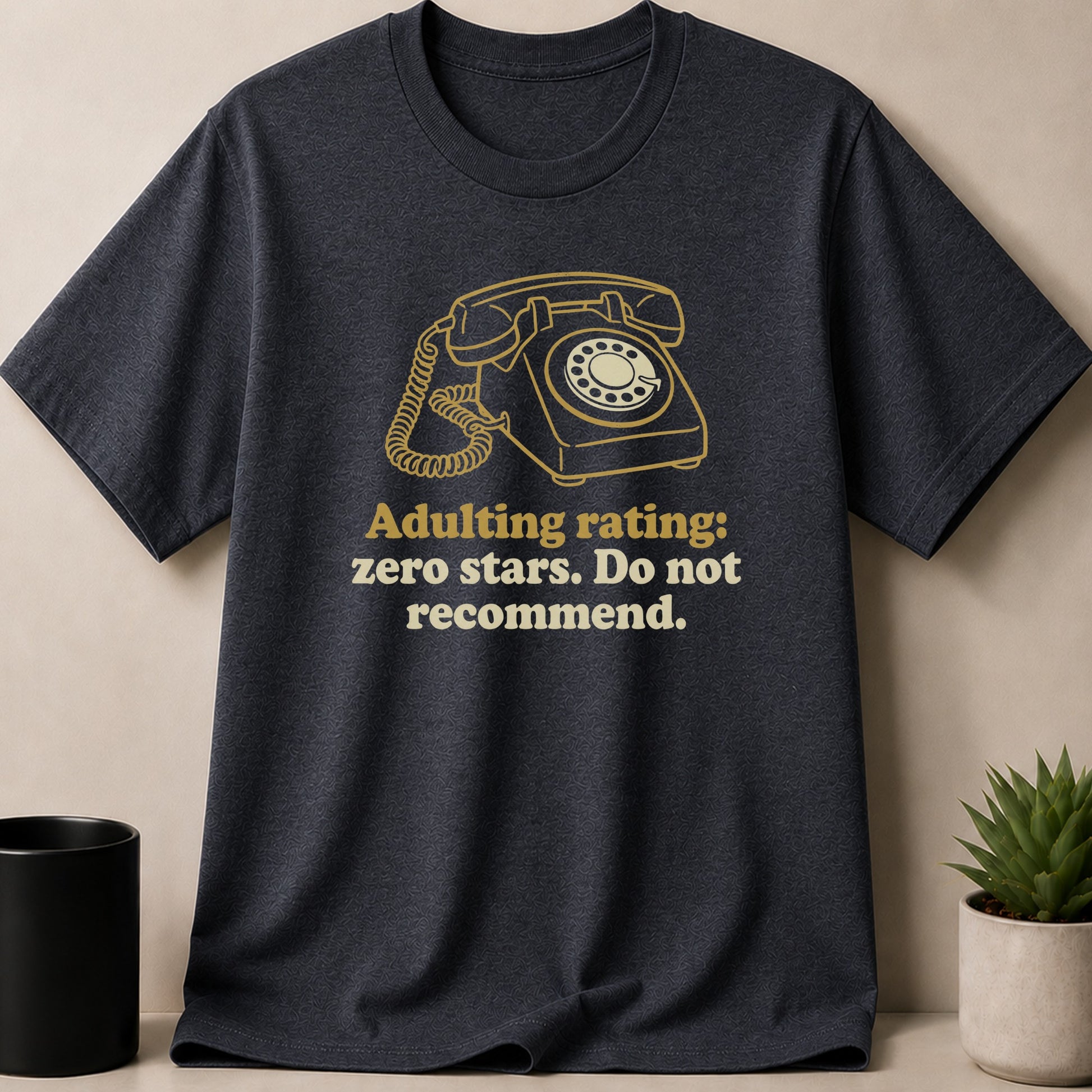 Dark gray t-shirt with gold rotary phone graphic and "Adulting rating: zero stars. Do not recommend." text.