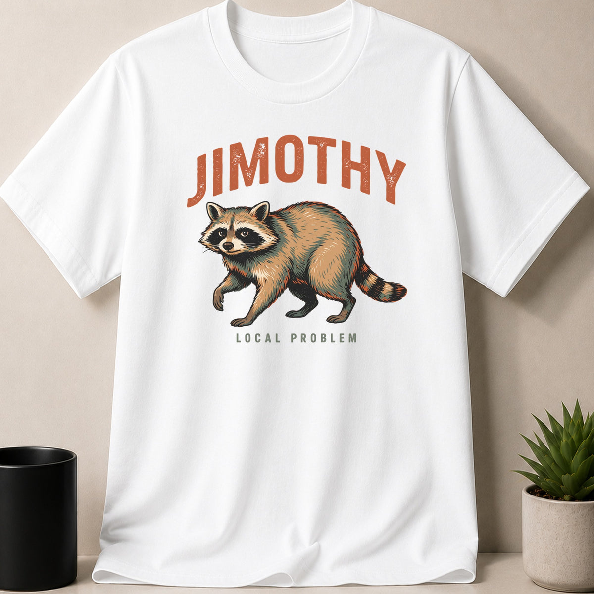 White t-shirt with raccoon graphic and text "JIMOTHY LOCAL PROBLEM".