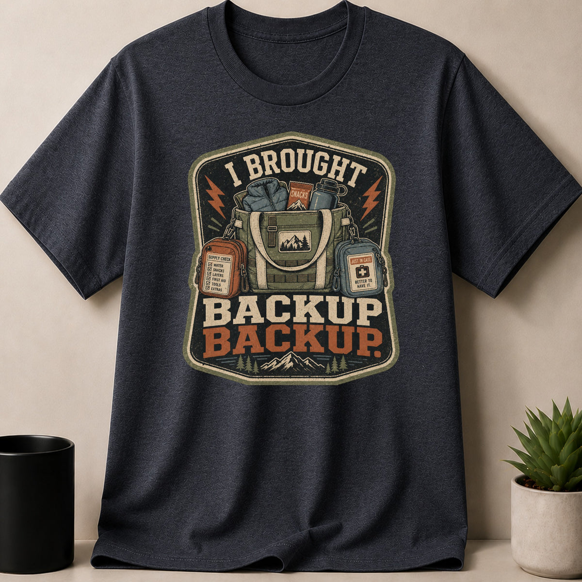 Dark Heather t-shirt — T-shirt with graphic that reads "I BROUGHT BACKUP BACKUP" and camping gear.