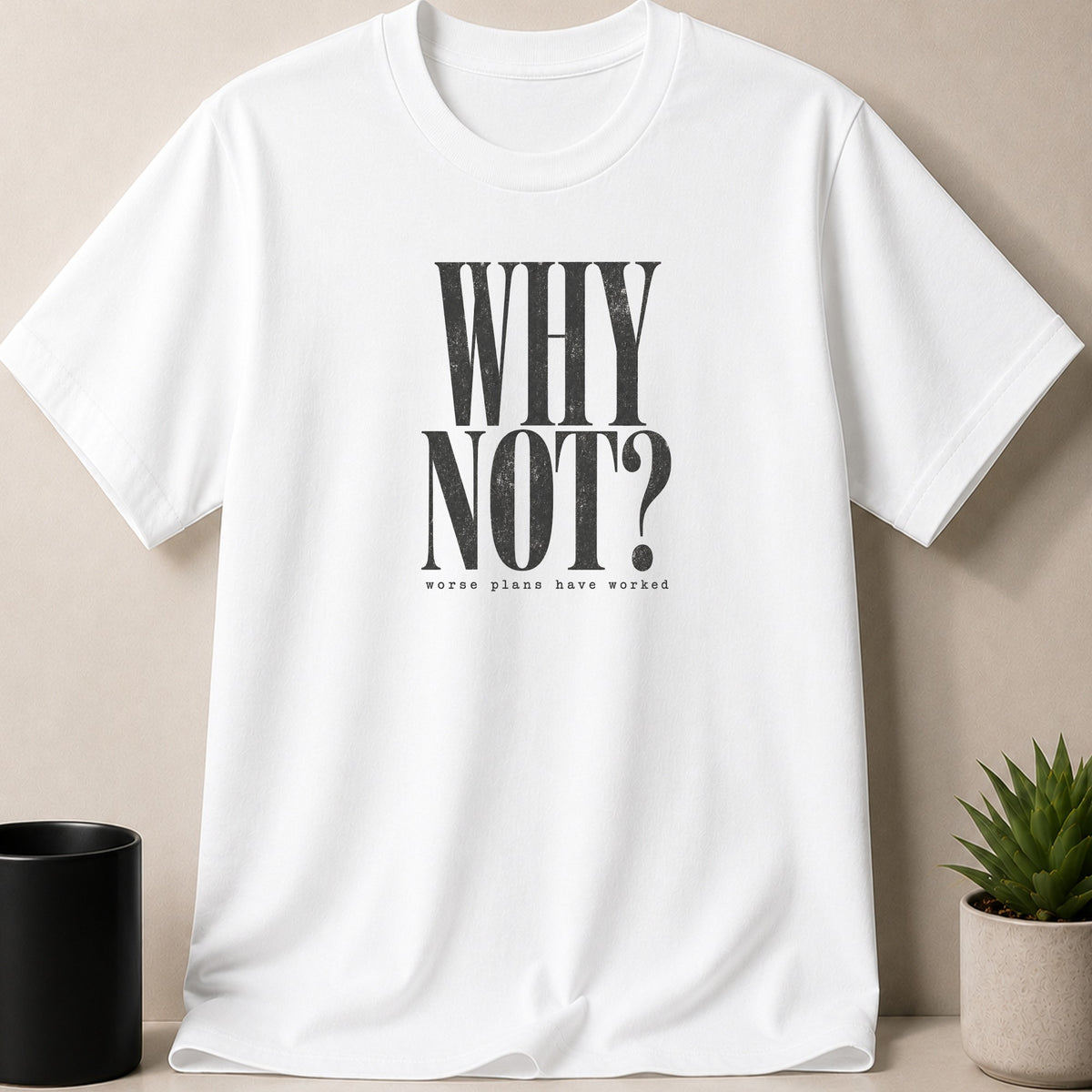 White t-shirt with distressed black text "WHY NOT?" and "worse plans have worked".