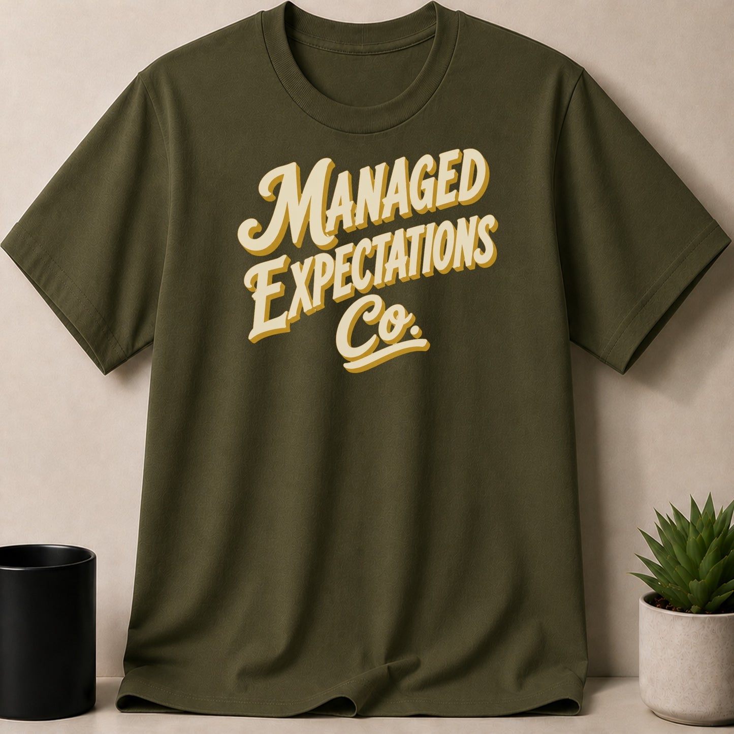 Olive green t-shirt with "MANAGED EXPECTATIONS Co." text.