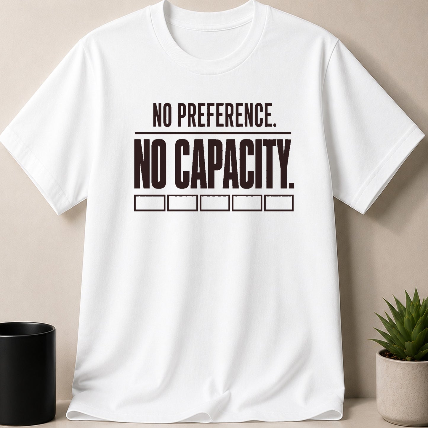 White t-shirt with black text reading "NO PREFERENCE. NO CAPACITY."