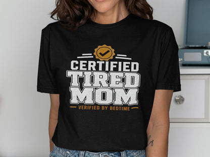 Black t-shirt with "Certified Tired Mom Verified by Bedtime" text.