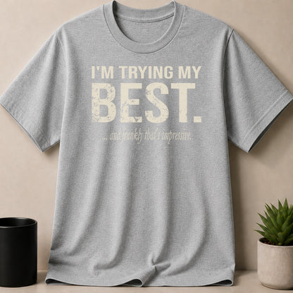 Heather grey t-shirt with distressed text "I'M TRYING MY BEST. ...and frankly that's impressive."
