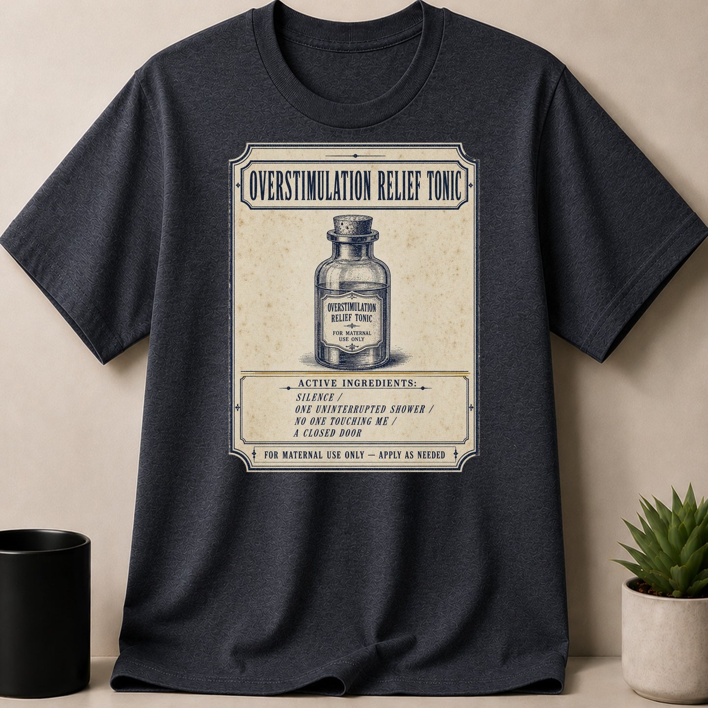 Dark grey t-shirt with "Overstimulation Relief Tonic" label design.
