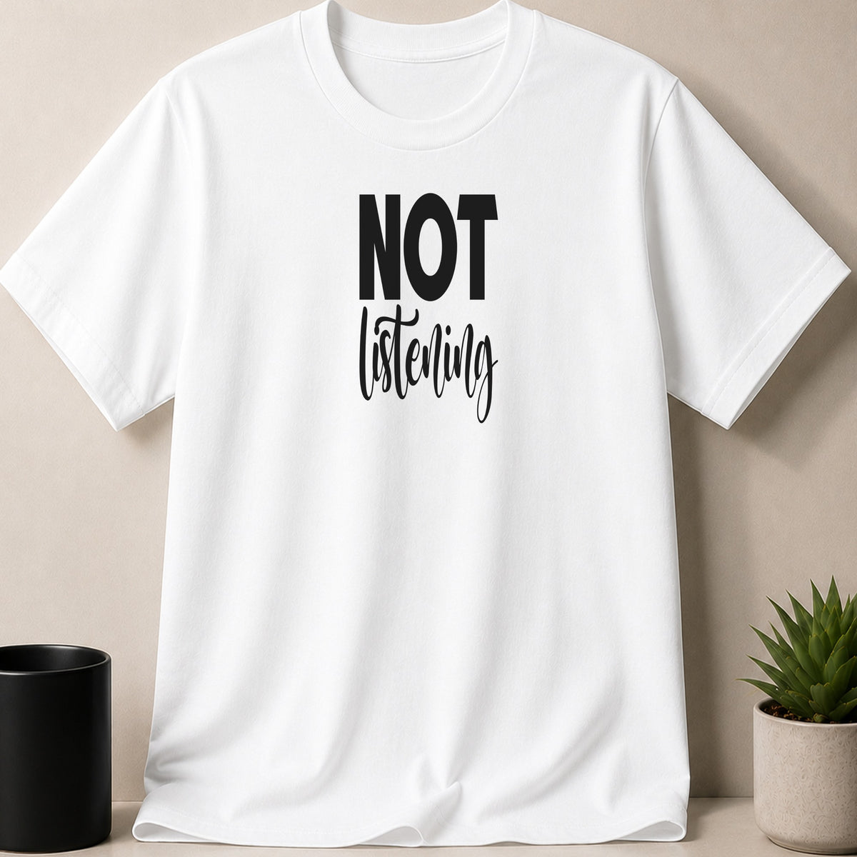 White t-shirt with black text that reads "NOT listening".