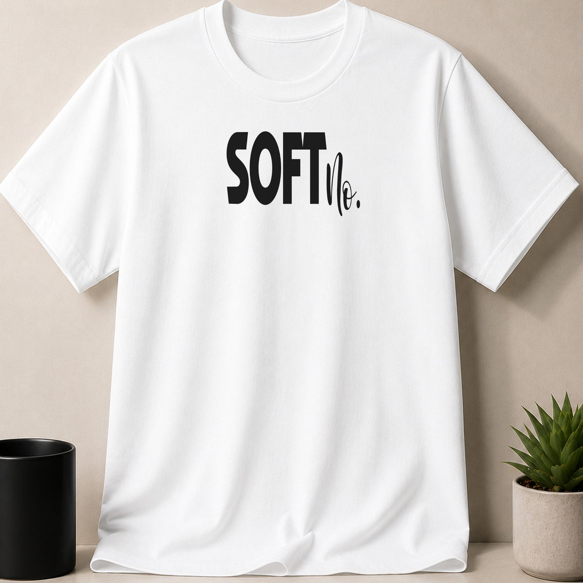 White t-shirt with black "SOFT The." graphic.