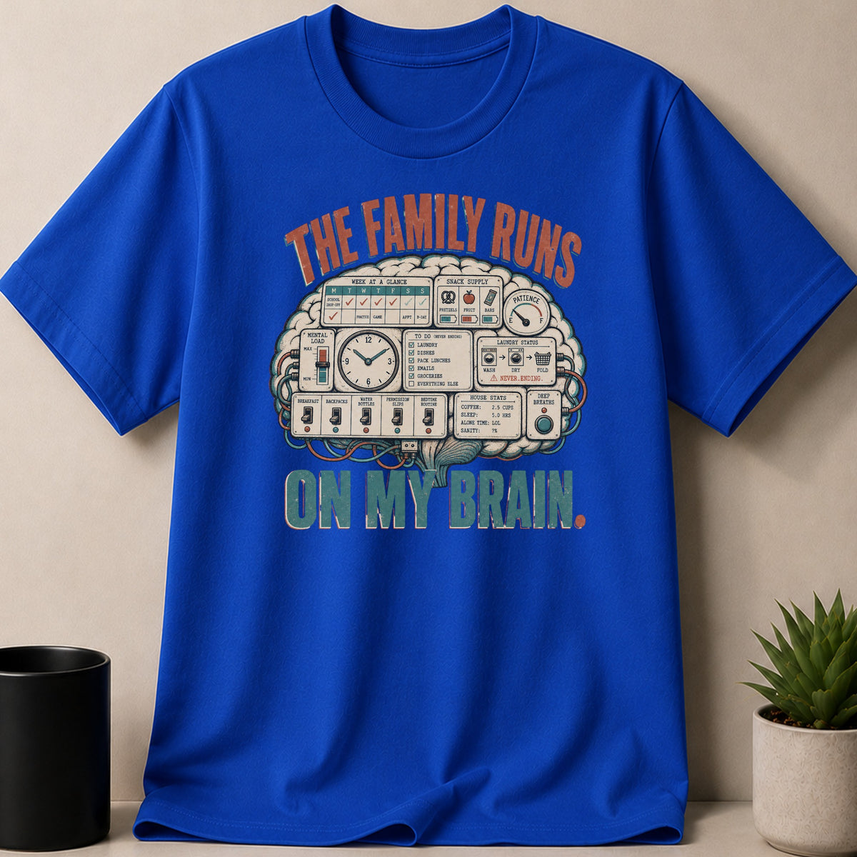 Blue t-shirt with graphic "The family runs on my brain" and brain-themed labels.